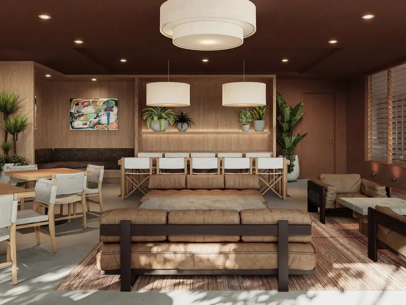 A lounge with a long sofa under drum pendants, timber walls and potted palms