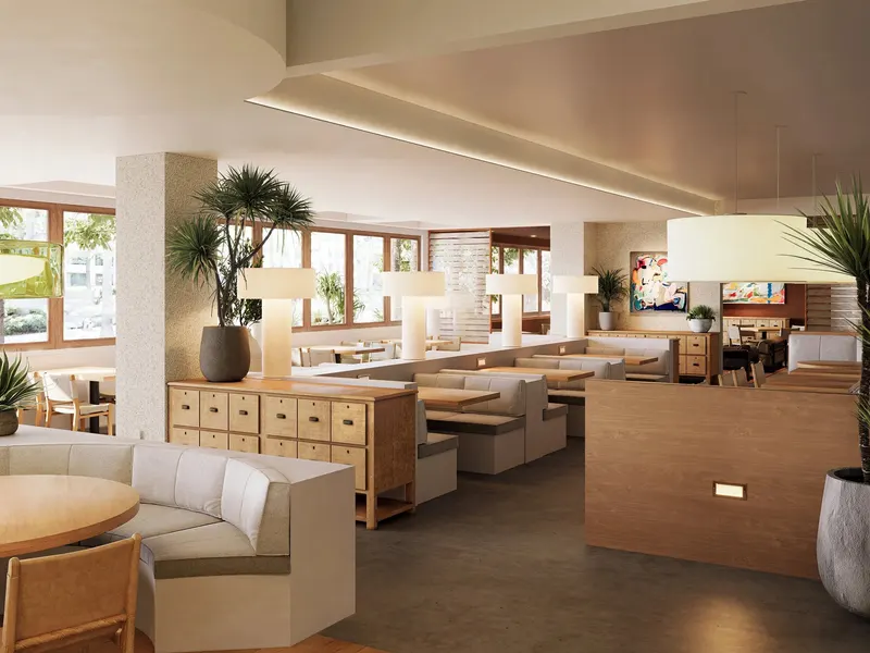 A bright dining room with curved booths, palms and a timber partition