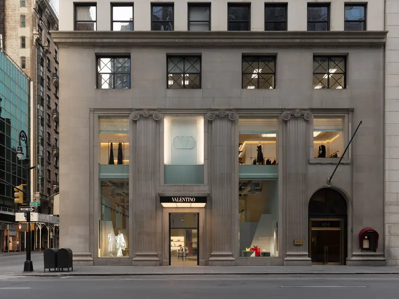 A boutique storefront set between stone columns in a classical office building
