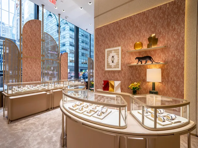A jewelry showroom with curved glass display cases and floor-to-ceiling windows