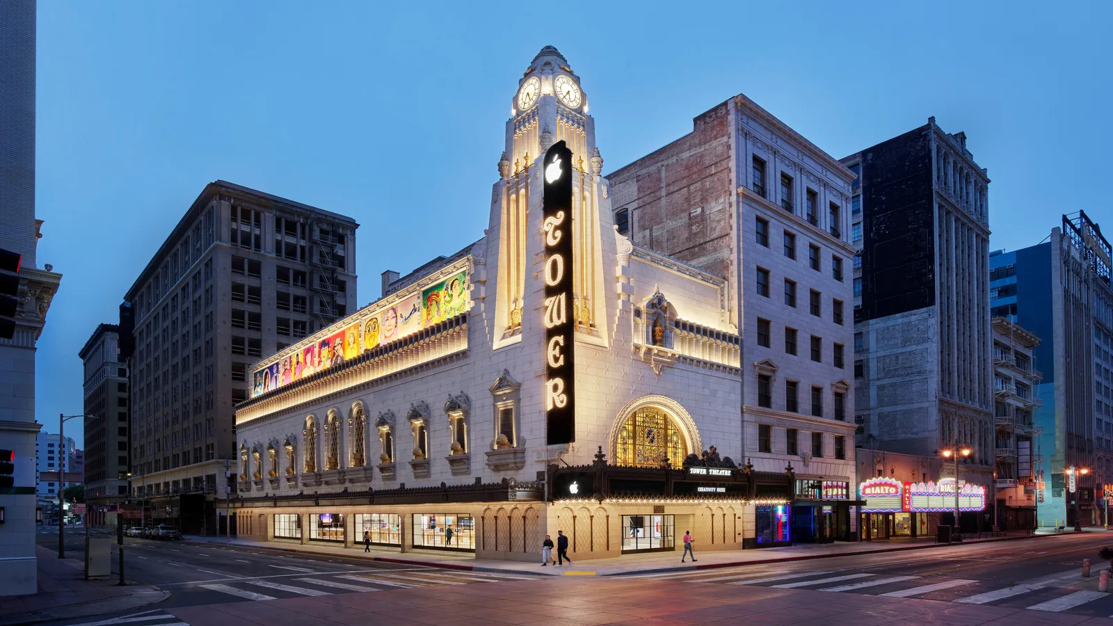 The restored theatre at dusk with its marquee and clock tower lit