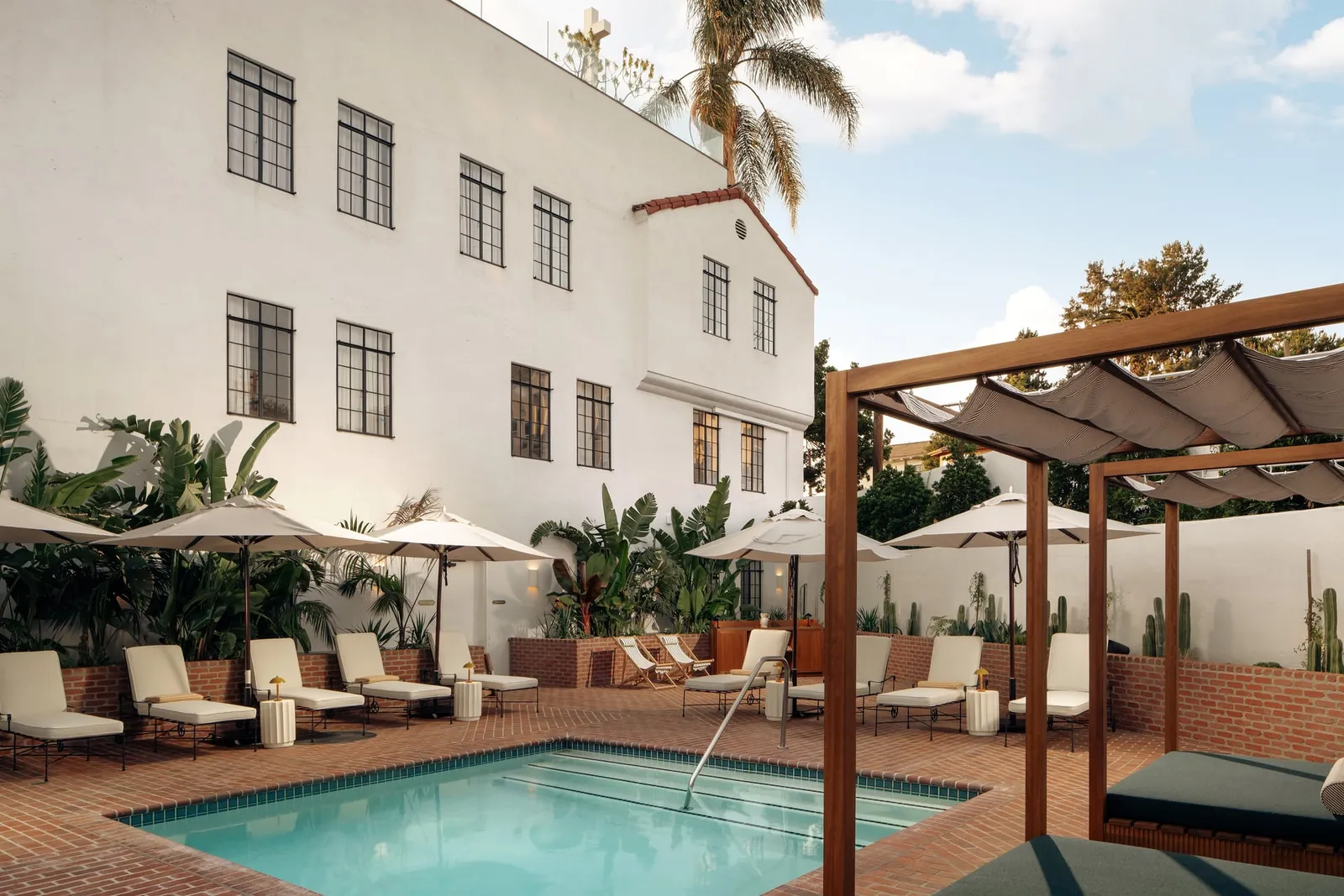 A hotel courtyard with a pool beside a converted church building