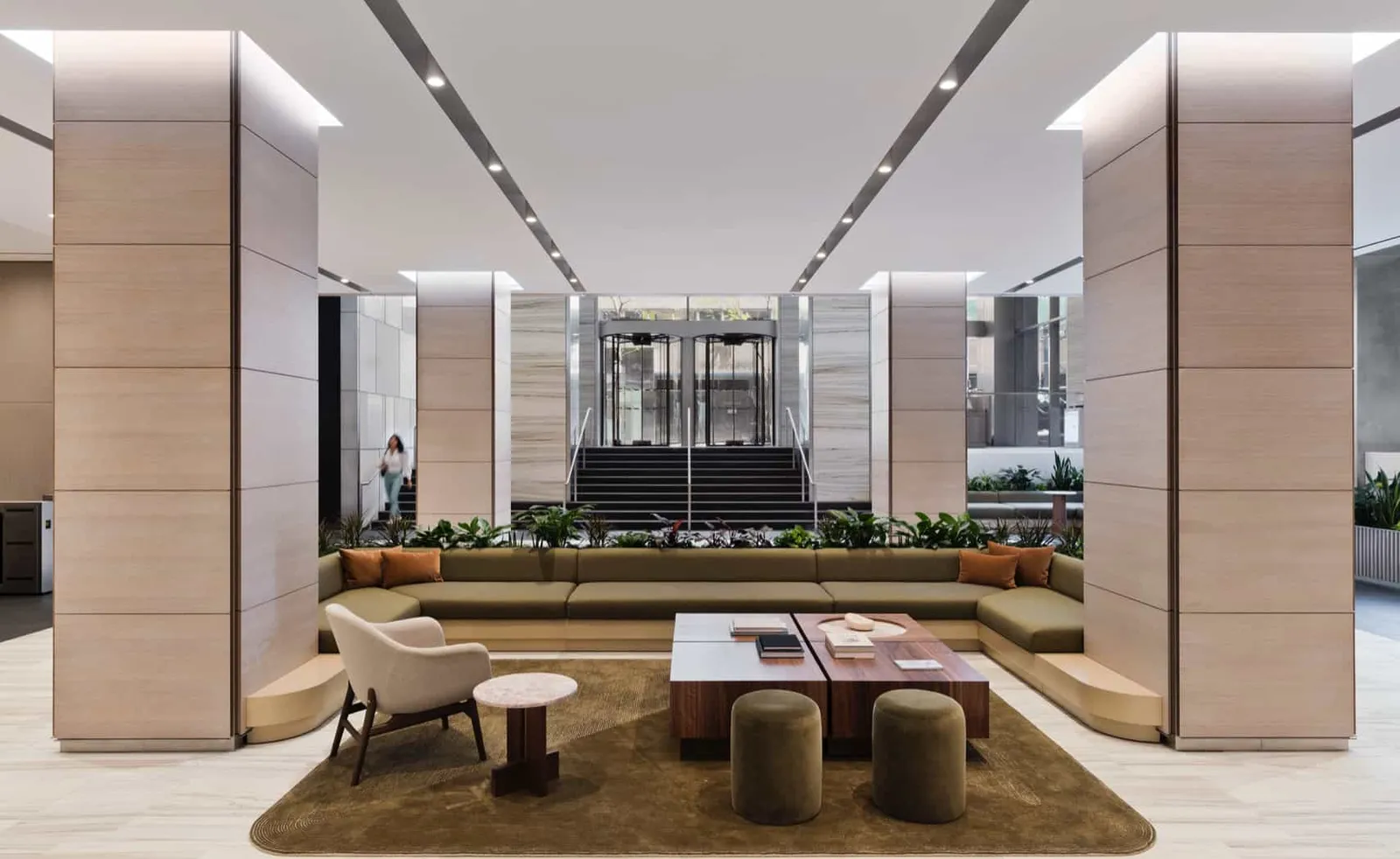 An office building lobby with stone columns and seating