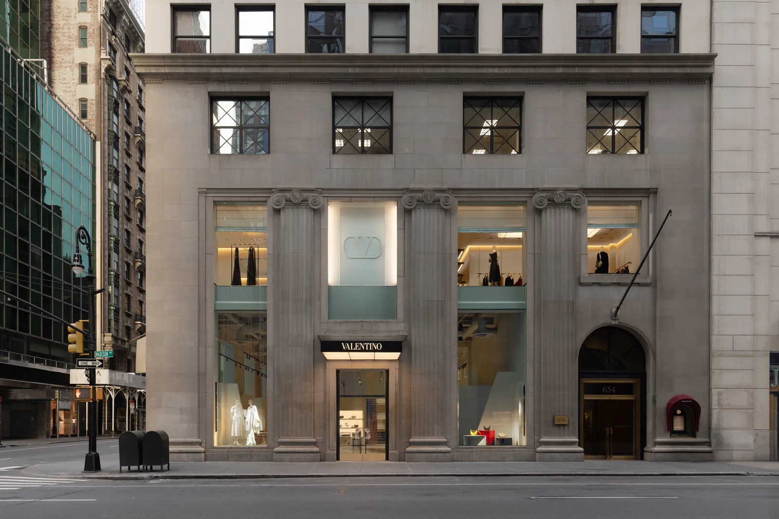 A boutique storefront set between stone columns in a classical office building